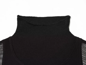 Detailed macro view of black knit fabric texture and high-neck collar of this stylish dress