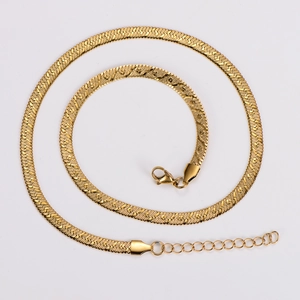 Detail of golden flat snake chain necklace with textured blade pattern and lobster clasp