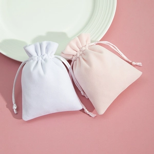 Elegant plush velvet drawstring pouches in white and pink for jewelry gift packaging