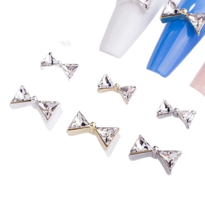 Bowtie crystal nail art charms with K9 triangle rhinestones in gold and silver settings