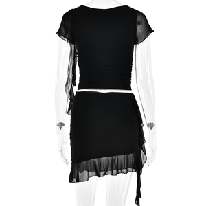 Detail of black two-piece set featuring sheer mesh sleeves and ruffled hem on back of skirt