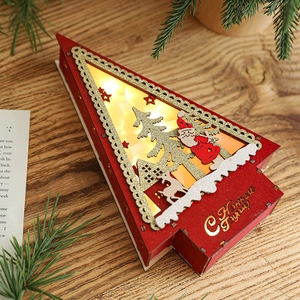 Lighted red wooden Christmas tree house ornament with golden cutout and warm LED light