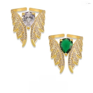 Detail of gold angel wing open rings with emerald and clear teardrop stones