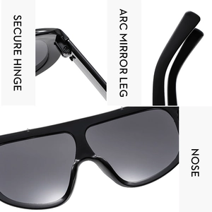 Detail view of oversize sunglasses showing secure hinges, arc mirror legs and nose pads
