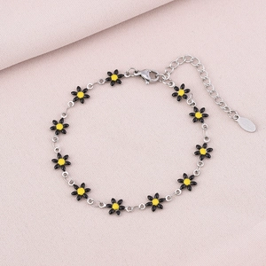 Detailed macro view of daisy flower bracelet with silver chain and adjustable clasp
