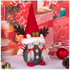 Detail view of a plush Christmas gnome with festive antlers and a long pointed hat