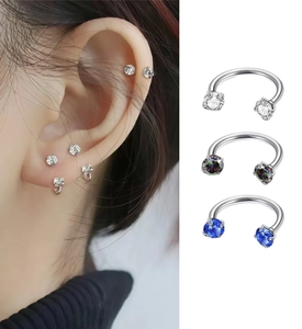 Detail of F136 titanium horseshoe lip rings with zircon stones in various colors
