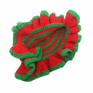 Detail of handmade crochet ruffle hat with festive red and green yarn texture