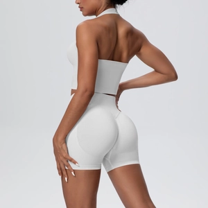 Back view of white halter yoga bra and high waist lifting shorts on a model