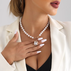 Elegant pearl necklace with rectangle zircon pendant and OT clasp worn by a model