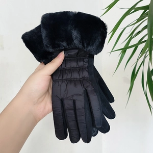 Dettaglio guanti invernali caldi in tessuto trapuntato, polsini in ecopelliccia e touch screen