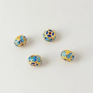Macro detail of 18K gold plated cloisonné enamel round beads with blue butterfly patterns