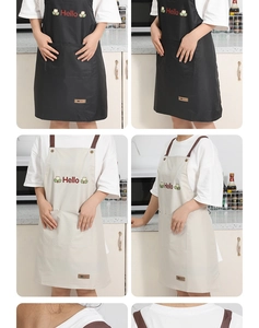 Detail of waterproof kitchen apron with pockets, adjustable straps, and Hello embroidery