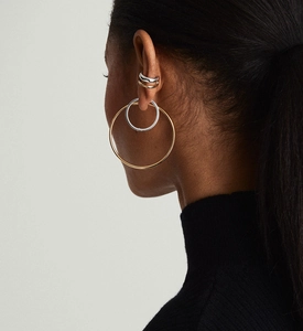 Detail view of layered gold and silver S925 sterling silver ear cuffs on model's ear