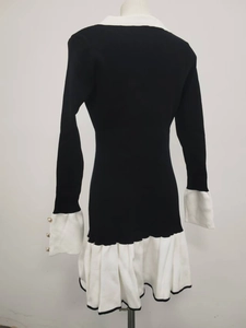 Back view of slim knit dress featuring ruffled hem and elegant black and white trim