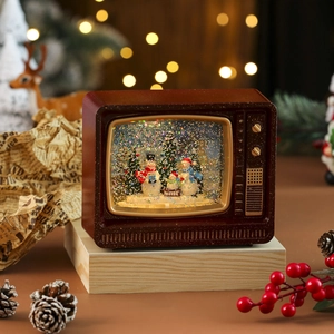 Detail of retro TV Christmas snow globe featuring festive snowmen and swirling glitter