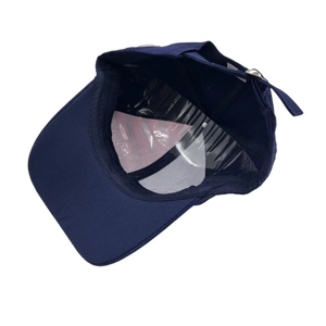 Navy blue baseball cap interior view featuring adjustable strap and sunshade brim detail