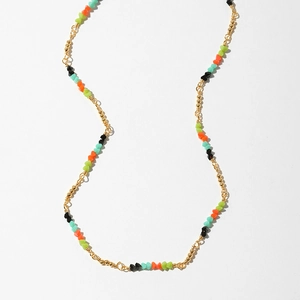 Bohemian colorful beaded necklace with evil eye charm and gold accents on white background