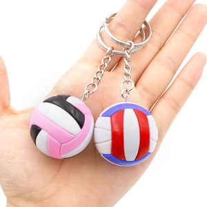 Macro detail of volleyball keychains in two colors with textured stitching and silver rings