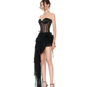 Detail of black boned corset top with layered asymmetric tulle skirt and ruffle mesh texture