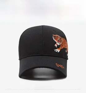 Detail view of a black baseball cap featuring vibrant tiger embroidery and side text