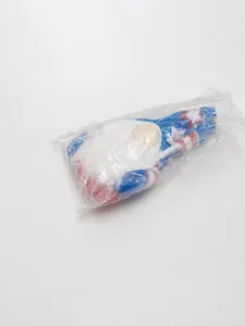 Close-up of patriotic gnome plush on industrial scale showing precise 0.050kg weight