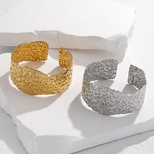 Adjustable wide stainless steel cuff bracelet with irregular hammered texture in gold and silver