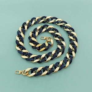 Detail of chunky resin chain strap with gold metal links and lobster clasps