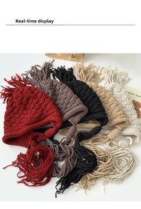 Detailed flat lay of knit earflap beanies in five colors with long braided ties