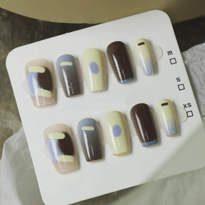 Press-on nail set featuring chocolate and cream colors with geometric hand-painted art