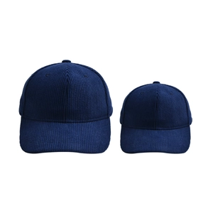Close-up of dark blue corduroy baseball caps in adult and child sizes for family look