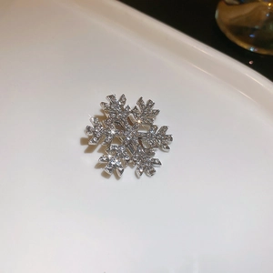 Macro detail of silver snowflake hair clip with sparkling zircon stones inlay