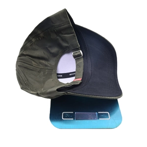 Outdoor camouflage baseball cap in olive green on a digital scale weighing 76.8 grams