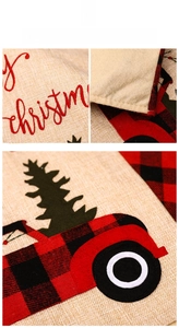 Detail of Christmas chair cover showing rustic burlap texture and embroidered truck motif