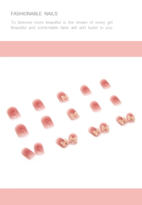 Macro detail of pink gradient press-on nails with 3D cream butterfly bow decorations