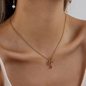 Close-up of 18K gold stainless steel necklace with pink zircon pendant on a model