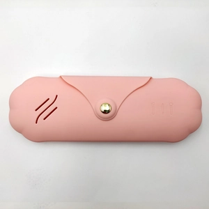 Pink silicone makeup brush holder with ventilation holes and golden snap button closure