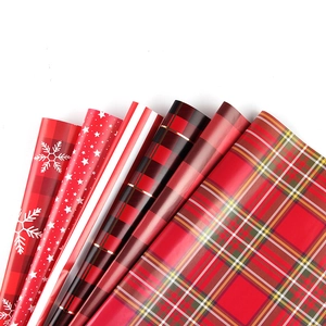 6 rolls of red Christmas gift wrapping paper with snowflakes, stars and classic plaid patterns