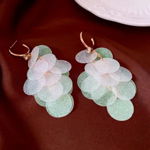 Sparkling mint green and white disc drop earrings with gold hoops and zircon accents