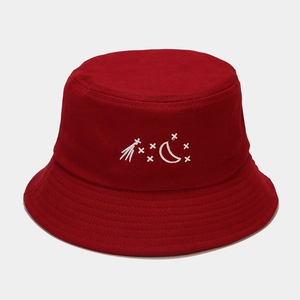 Detail of red cotton bucket hat featuring fine white moon and star embroidery on front