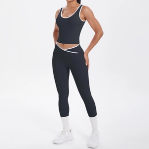 Detail of cross V-waist yoga pants and sports bra with contrast white binding