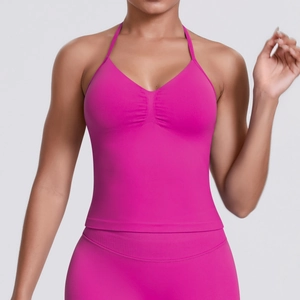 Detail of hot pink ribbed sports top with halter neck and ruching for yoga wear