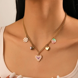 Detail view of gold stainless steel necklace with heart, flower, and strawberry charms