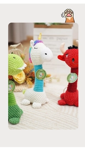 Detailed view of plush squeaky dog toys with textured fabric including dinosaur and unicorn