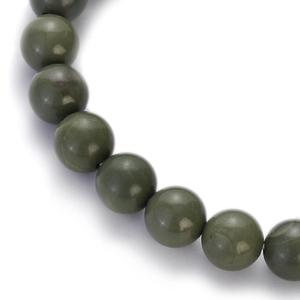 Detailed macro view of smooth dark green round natural stone beads on a bracelet