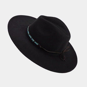 Detail of black wide brim fedora with bohemian turquoise beads and leather trim strap