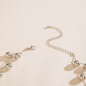 Macro shot of silver beaded necklace with lobster clasp and adjustable extension chain