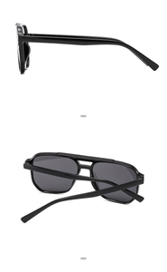 Detail view of double-bridge aviator sunglasses with black frames and sleek straight temples