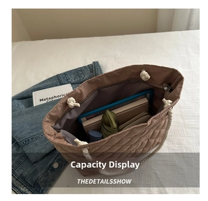 Détail de la grande capacité intérieure du sac cabas matelassé marron avec objets quotidiens