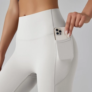 Detail of high waist yoga pants showing functional side pocket for a smartphone